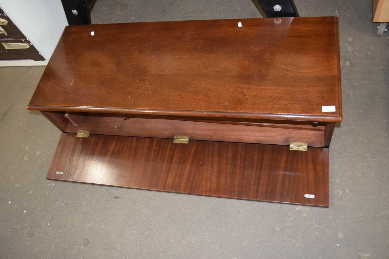 A narrow mahogany cabinet, possibly a wardrobe top box