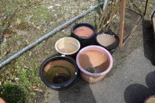 Five clay and terracotta plant pots