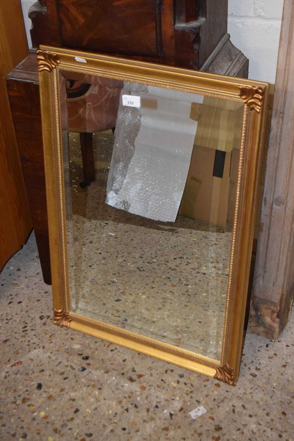 A modern rectangular gilt framed wall mirror