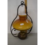 A brass and iron mounted hanging oil lamp