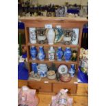 A miniature dresser containing various small reproduction Chinese vases and other ceramics