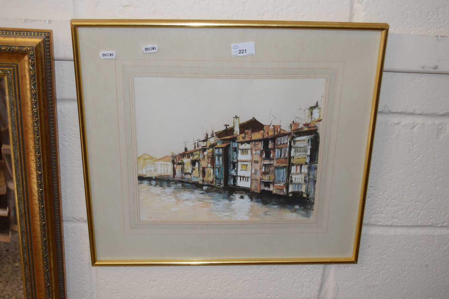 A 20th Century continental study riverside houses indistinctly signed, framed and glazed