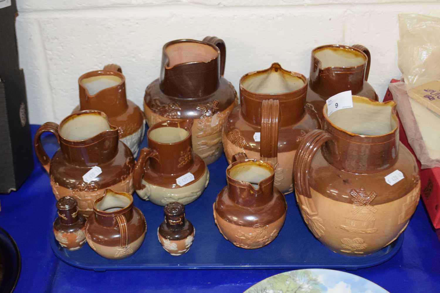A group of Royal Doulton and other stone ware harvest jugs and similar cruet items