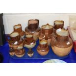 A group of Royal Doulton and other stone ware harvest jugs and similar cruet items