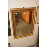 A modern rectangular bevelled wall mirror in gilt finish frame
