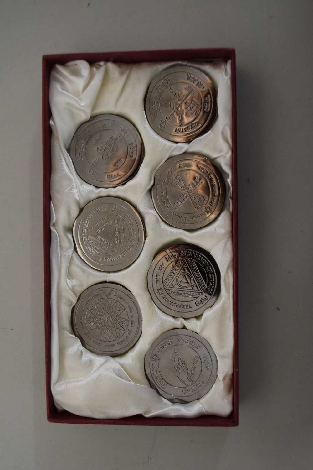 A case of seven Israeli base metal Zodiac medallions