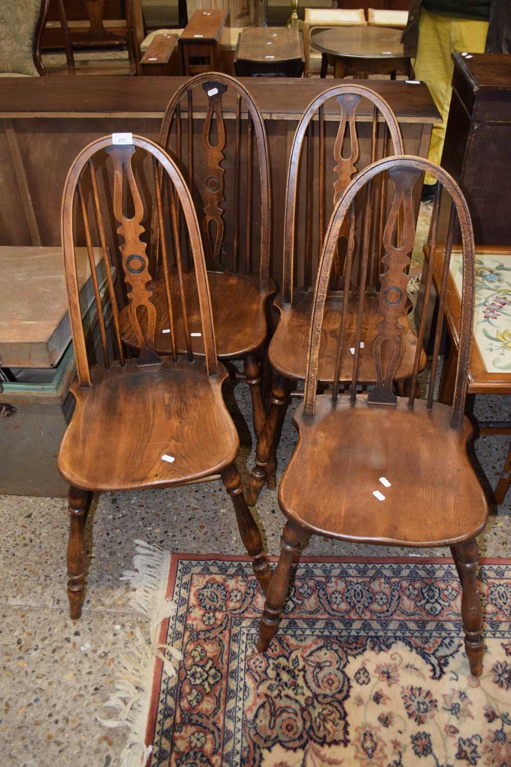 A set of four elm seat and stick back kitchen chairs