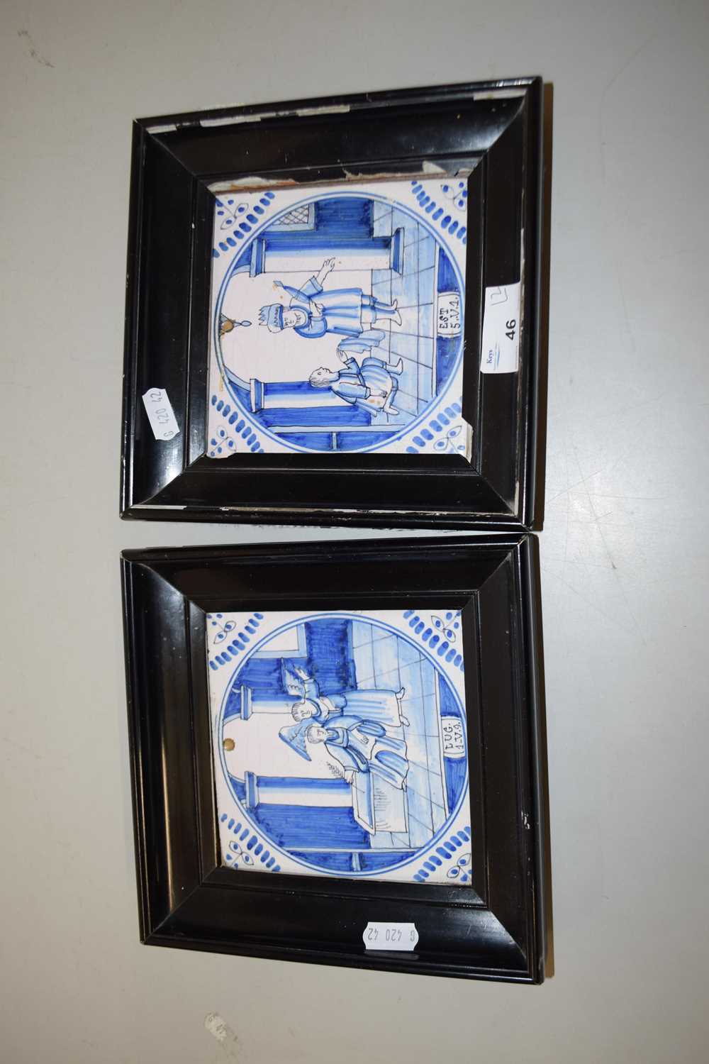 A pair of Delft tiles in ebonised frames