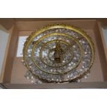 A four tier circular ceiling light with glass drapes