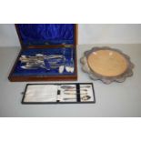 A case of fish cutlery, silver plate mounted bread board and a further case of silver plated