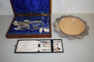 A case of fish cutlery, silver plate mounted bread board and a further case of silver plated