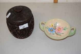 A carved wooden tobacco jar together with a further floral decorated dish