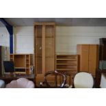 A suite of modern light wood lounge furniture comprising entertainment cabinet, display cabinet,