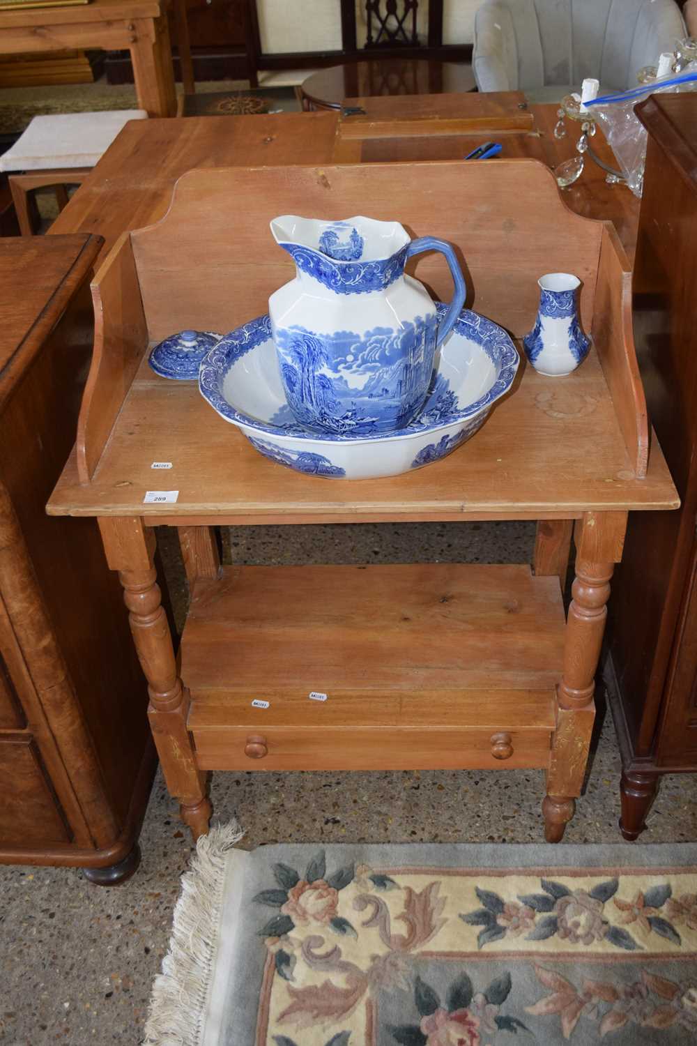 A pine wash stand containing a blue and white wash bowl, jug and other items by Cauldon