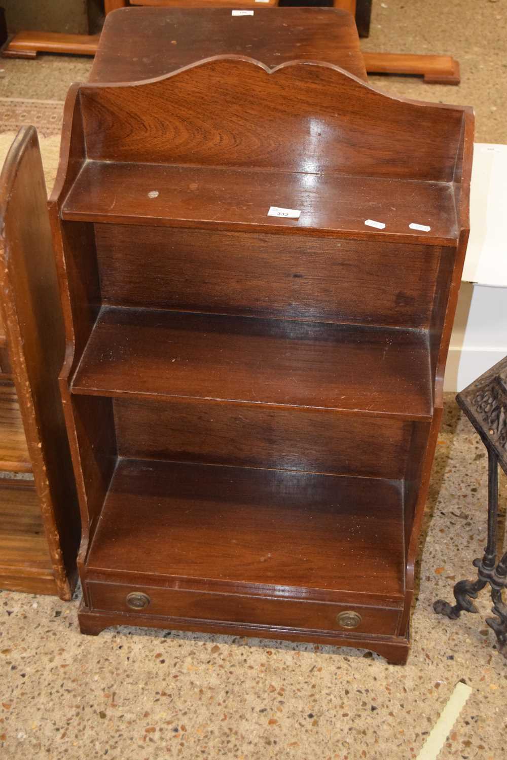 A reproduction mahogany veneered waterfall style small bookcase with base drawer