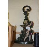 Cast iron cherub formed candlestick