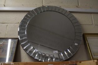 A modern circular wall mirror