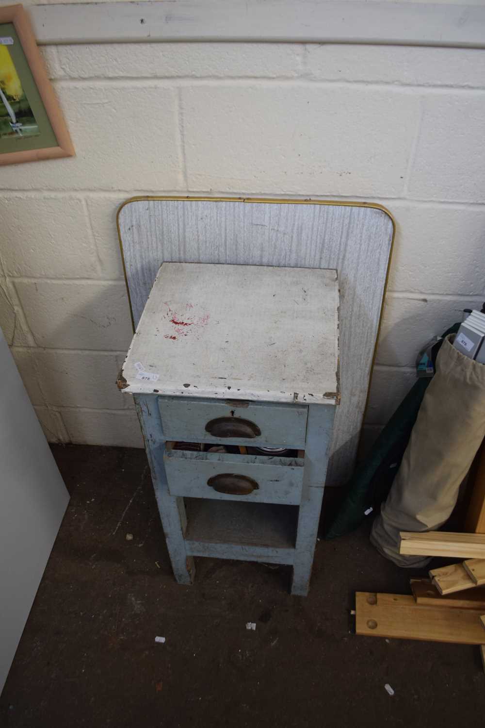 A small two drawer cabinet and a folding table