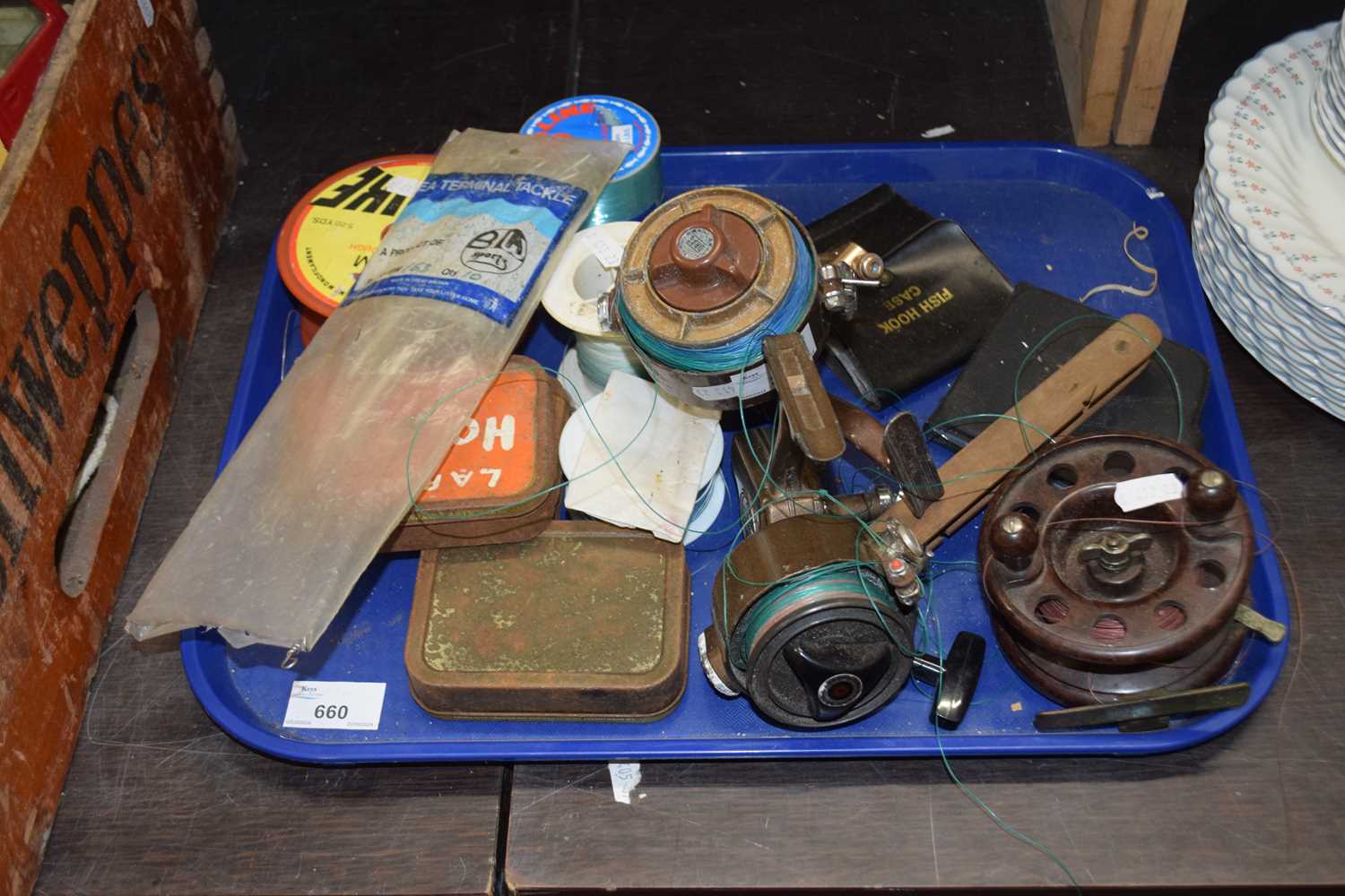 Tray containing a quantity of fishing reels including a vintage bakelite example