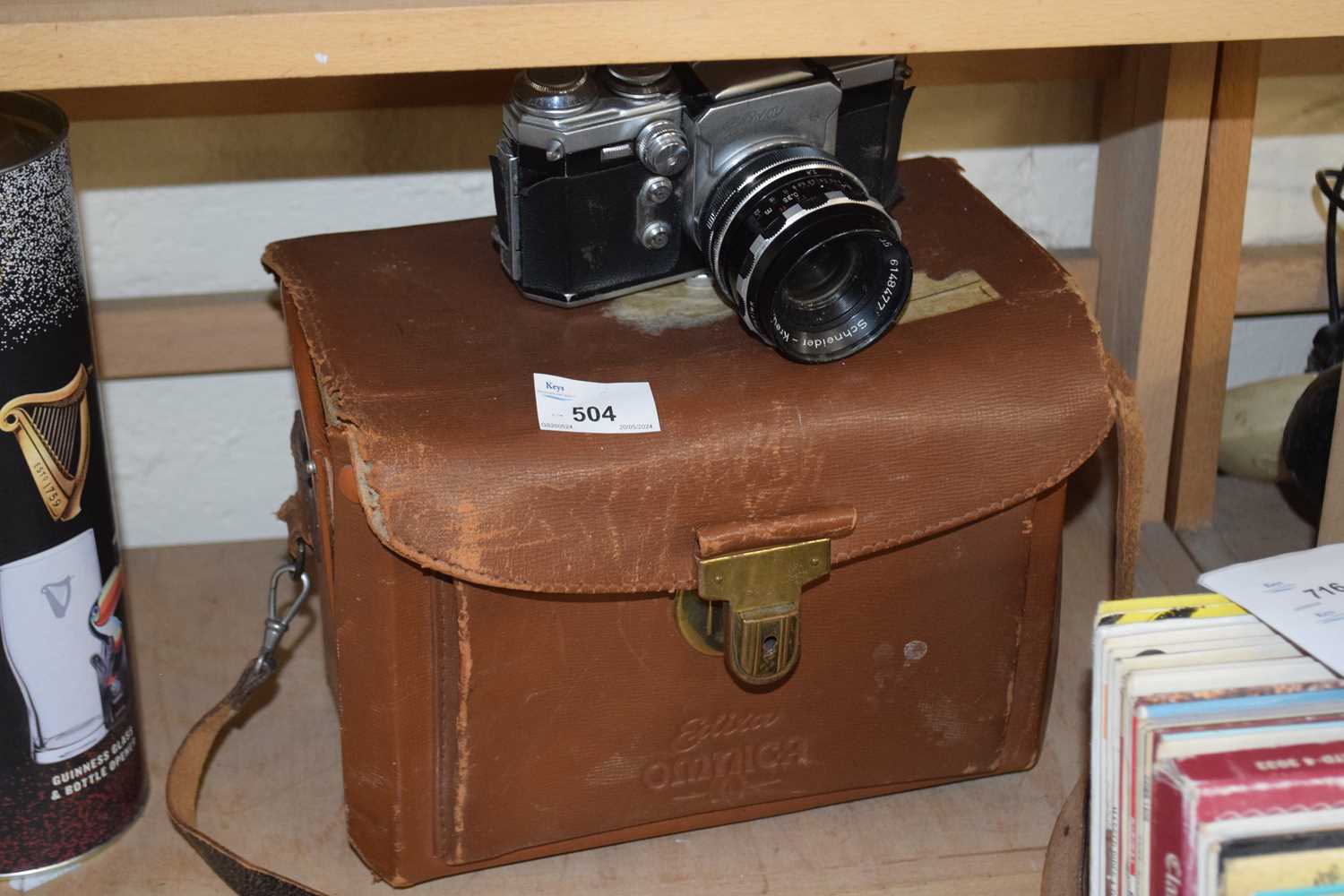 An Edixa Reflex-B camera with leather case and various accessories