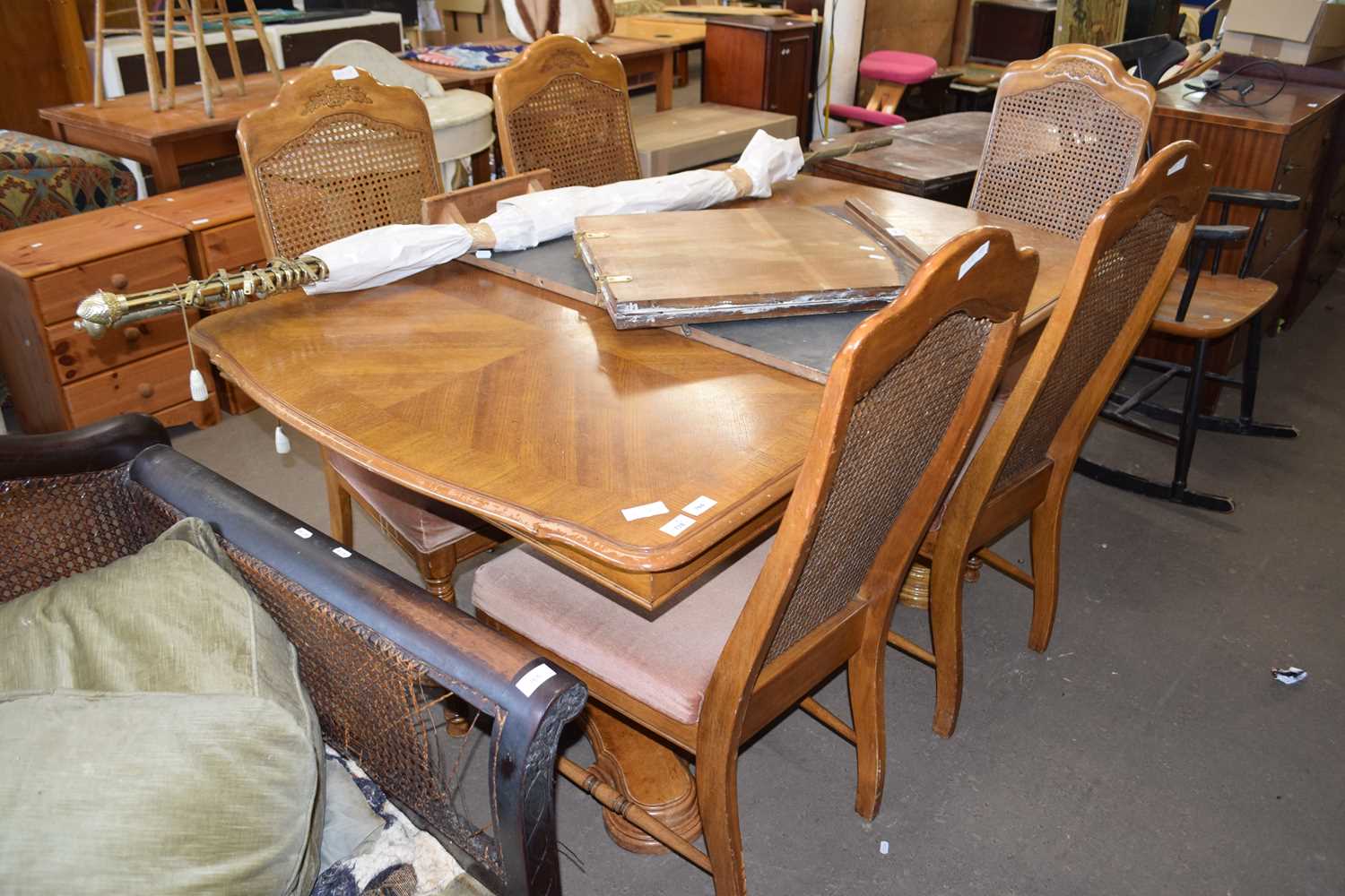 An oak veneered dining table and five chairs