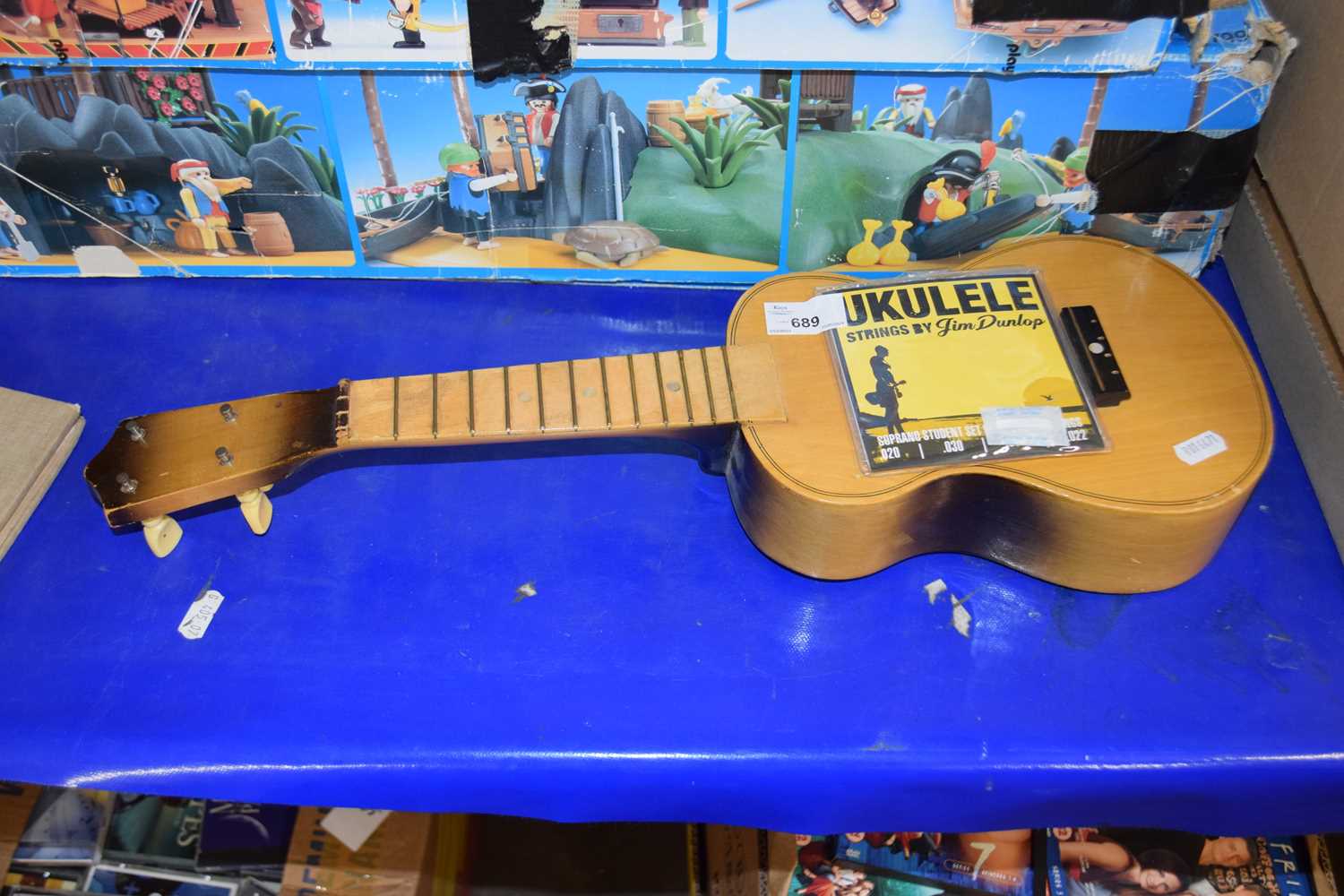 A ukelele with instruction manual by Jim Dunlop