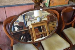 Early 20th Century oval bevelled wall mirror in a hardwood frame