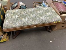 Upholstererd footstool with ornately carved feet