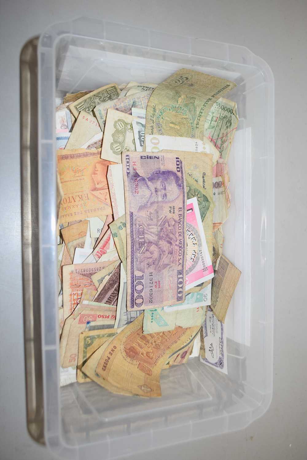 A box of world bank notes, mainly in heavily used/damaged condition