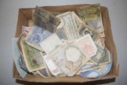 A box of world bank notes in heavily circulated/damaged condition