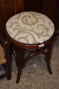A bentwood framed circular topped stool