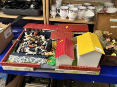 A child's toy farm together with a quantity of moulded plastic farm animals