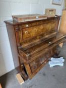 A Gilbert of London walnut cased piano with simulated ivory keys