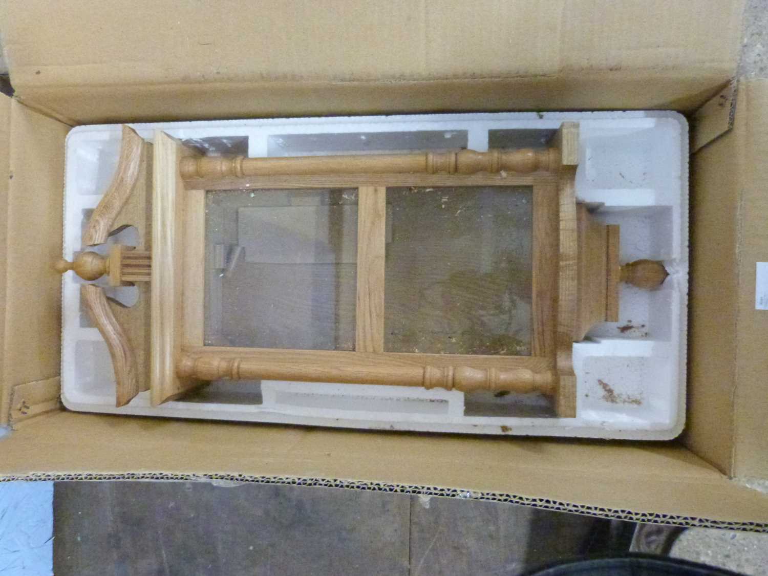 A modern oak wall clock case, lacking movement