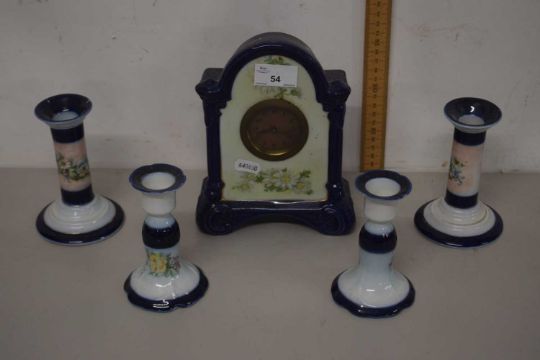 Two pairs of porcelain dressing table candlesticks and a similar clock