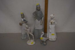 A group of various figurines to include a Lladro swan and others