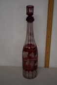 A Bohemian red and clear glass decanter with vine leaf decoration