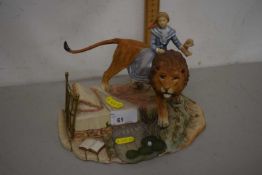 Modern resin model of girl on lions back