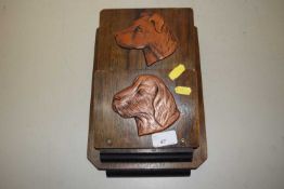 A wall mounted wooden letter rack with dog decoration