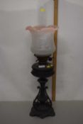 Cast metal based Victorian oil lamp with frosted glass shade