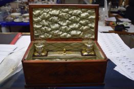 A French ladies travelling vanity box of hinged rectangular form, the veneered lid with brass