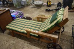Wooden garden lounger with cushion