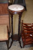 A reproduction hardwood plant stand on barley twist legs
