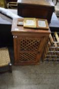 An Indian hardwood bedside cabinet with meshed door