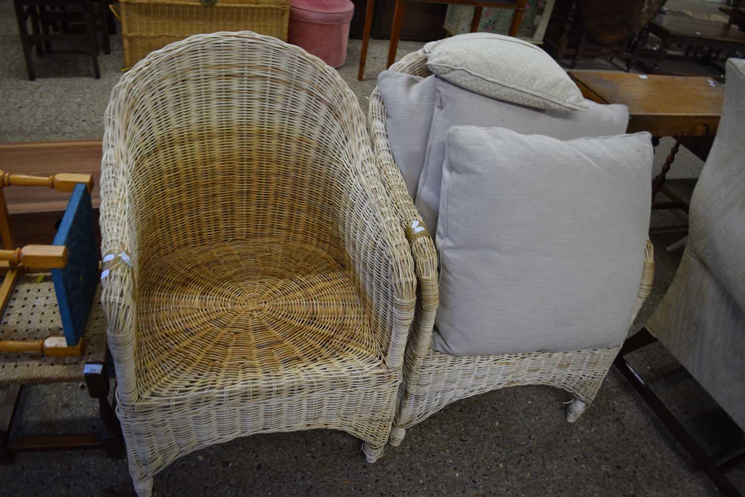 A pair of wicker work armchairs