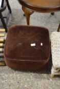 A brown upholstered footstool