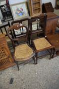 A Victorian balloon back chair with cane seat together with a further cane seated chair