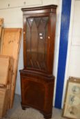 A glazed corner cabinet