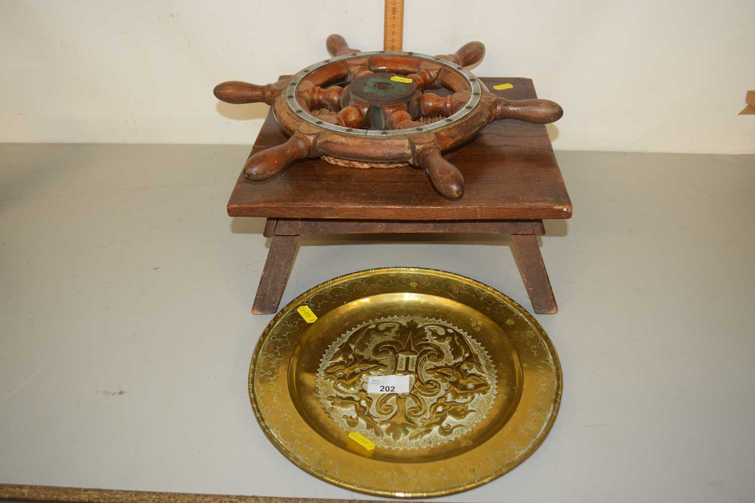 A brass tray, wooden ships wheel etc