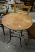 A metal framed cafe table with circular hardwood top
